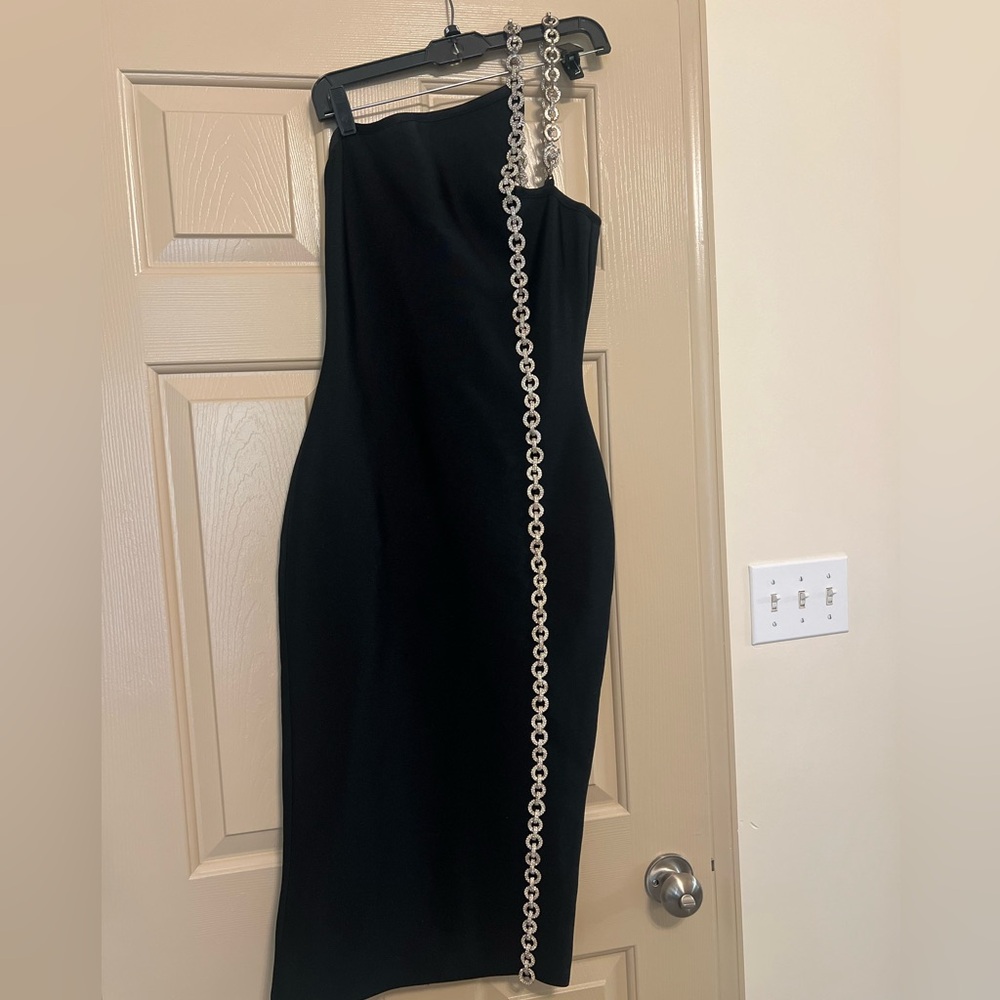 Medium blackk mini bandage dress with sequin embellished strap.